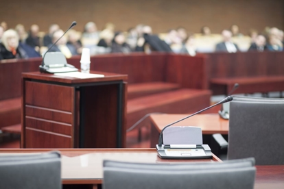 Empty witness stand in courtroom.