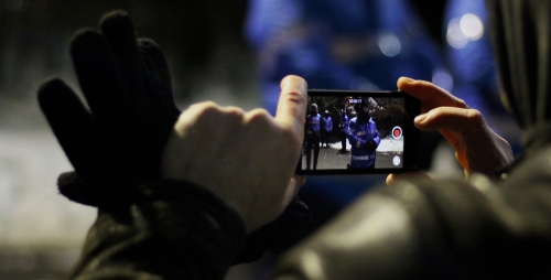 Bucharest, Romania - January 2017: Guy videotaping the police