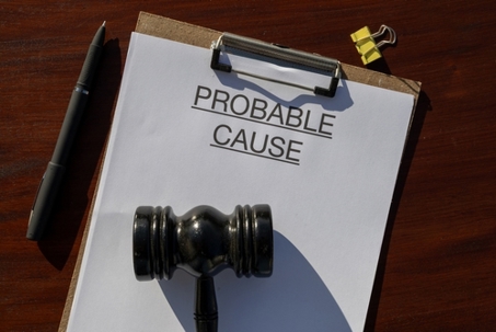 Legal Threshold: Probable Cause Document with Gavel on Wooden Desk